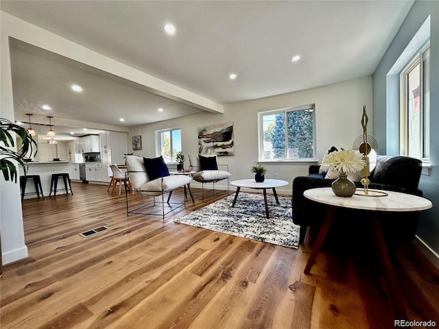 601 W Layton Ave, Englewood, CO 80110 - living room featuring wood finished floors, recessed lighting, and beam ceiling