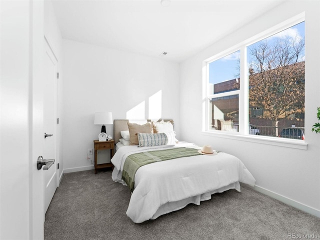 bedroom featuring dark colored carpet