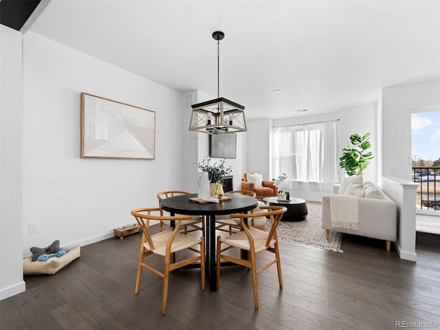 dining area with a chandelier and dark hardwood / wood-style flooring