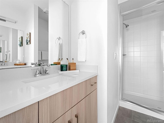 bathroom featuring tile flooring, walk in shower, and vanity