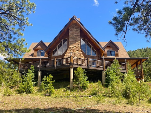 rear view of house with a wooden deck