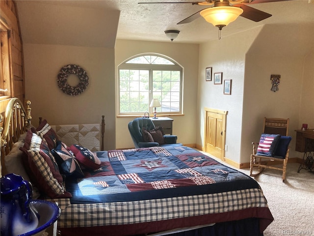 bedroom with a textured ceiling, carpet floors, and ceiling fan