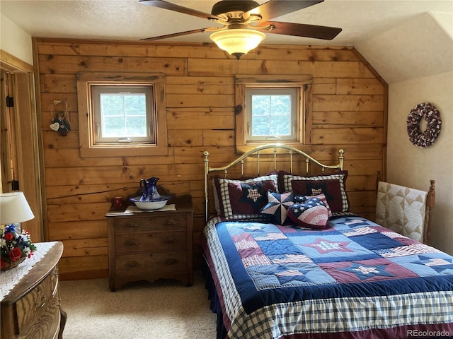 carpeted bedroom featuring a textured ceiling, multiple windows, lofted ceiling, and ceiling fan