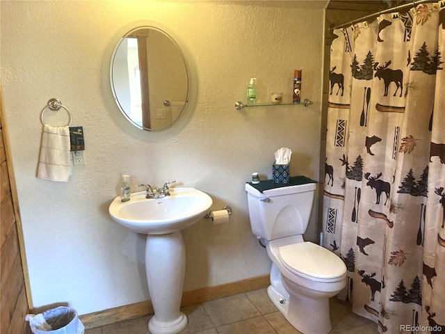 bathroom featuring tile patterned flooring and toilet