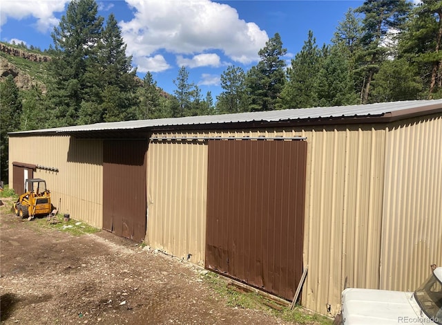 view of home's exterior with an outdoor structure