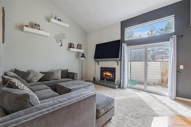 living area featuring high vaulted ceiling, a fireplace, carpet flooring, visible vents, and baseboards