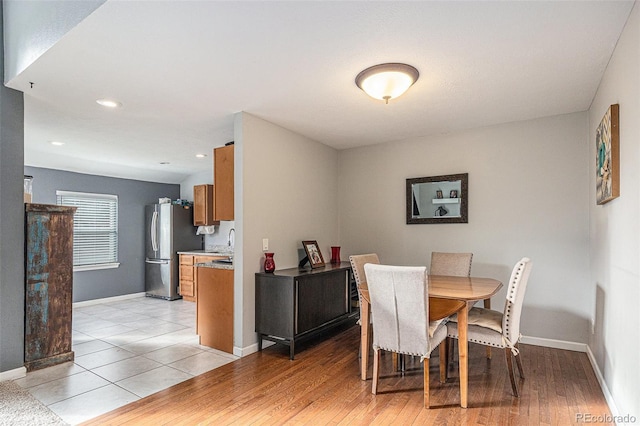 dining space featuring light wood-type flooring, baseboards, and recessed lighting