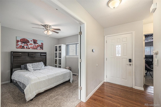 entrance foyer featuring ceiling fan, a textured ceiling, wood finished floors, and baseboards