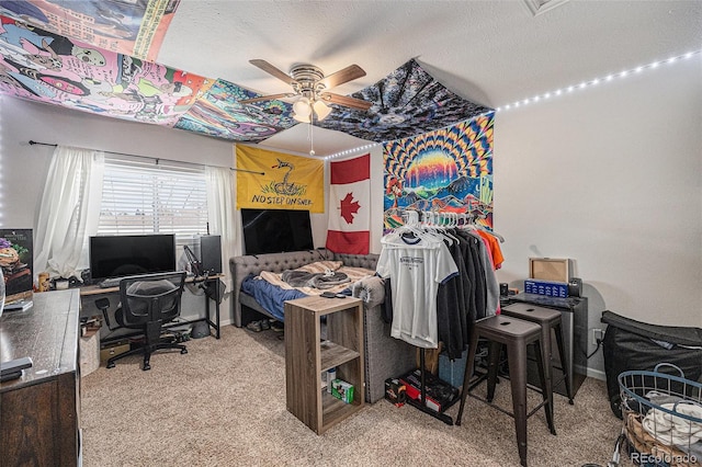 bedroom featuring a textured ceiling, carpet flooring, and a ceiling fan