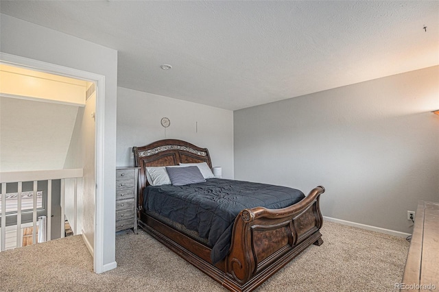 bedroom featuring carpet floors, baseboards, and a textured ceiling