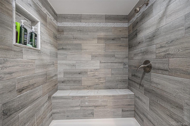 full bathroom featuring tiled shower