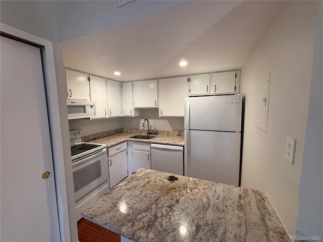 kitchen featuring white cabinetry, sink, light stone countertops, and appliances with stainless steel finishes