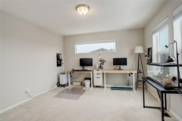 home office featuring light carpet and baseboards