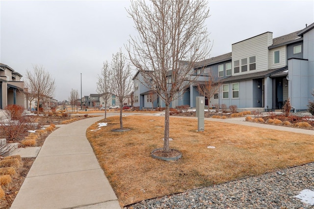 view of property's community with a residential view and a yard