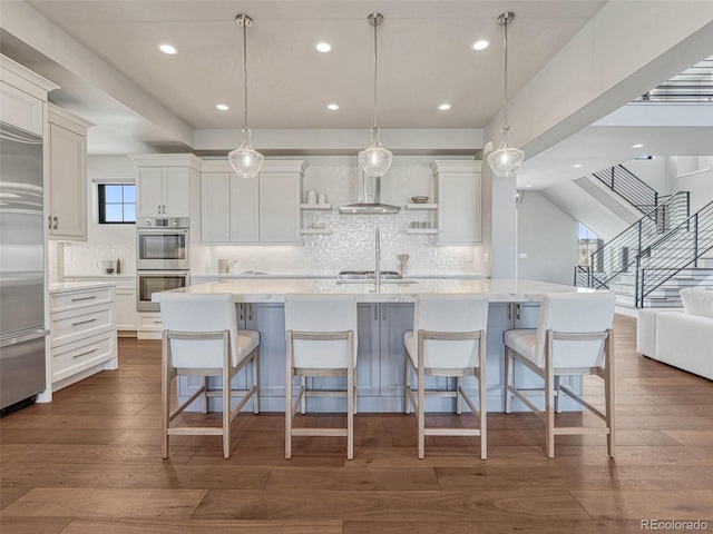 kitchen featuring open shelves, stainless steel appliances, dark wood-type flooring, white cabinets, and wall chimney exhaust hood