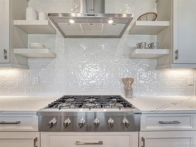 kitchen with under cabinet range hood, stainless steel gas stovetop, light countertops, and open shelves