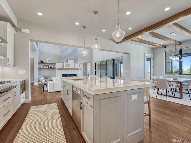 kitchen with dishwasher, dark wood-type flooring, white cabinets, and a sink