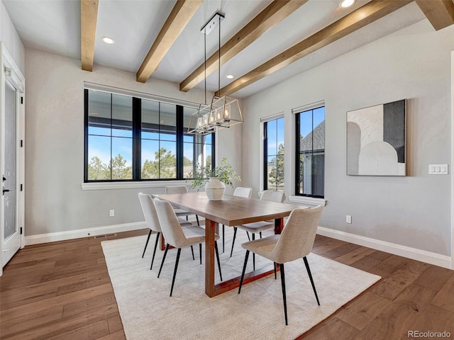 dining area with visible vents, baseboards, hardwood / wood-style flooring, beamed ceiling, and a chandelier