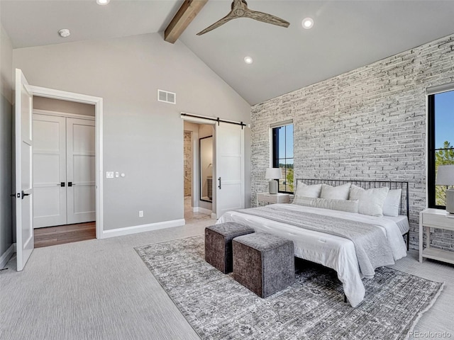 carpeted bedroom featuring visible vents, baseboards, beamed ceiling, a barn door, and high vaulted ceiling