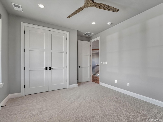 unfurnished bedroom featuring recessed lighting, visible vents, light colored carpet, and baseboards