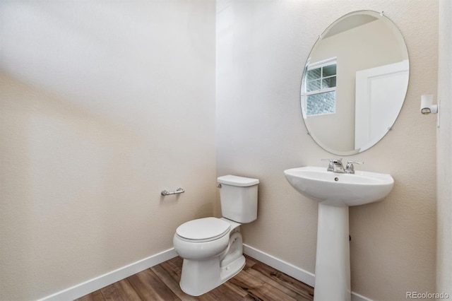 bathroom with sink, hardwood / wood-style floors, and toilet