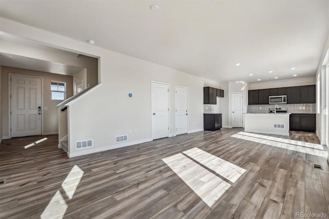 unfurnished living room with hardwood / wood-style flooring