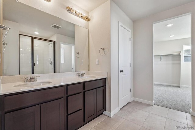 bathroom featuring vanity, tile patterned floors, and an enclosed shower