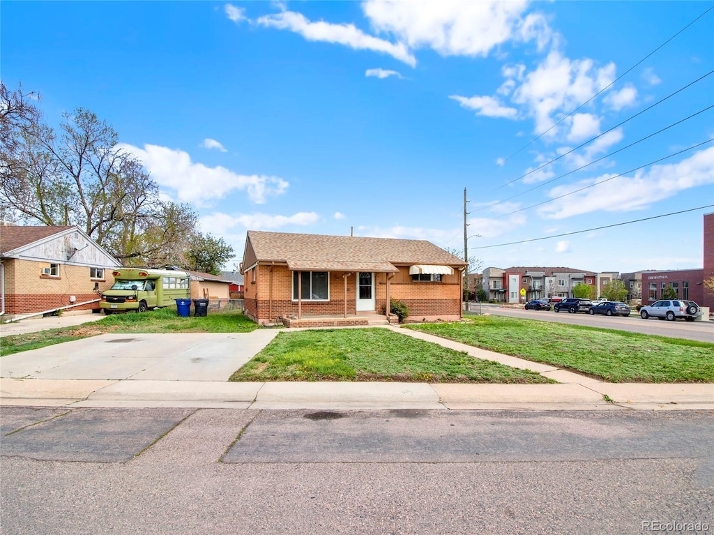6800 Fern Dr, Denver, CO 80221 - bungalow with a shingled roof, a front lawn, and brick siding