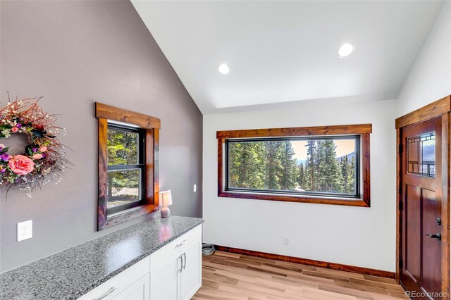 60 Jackson, Alma, CO 80420 - kitchen with vaulted ceiling, light wood-style floors, white cabinetry, dark stone countertops, and recessed lighting