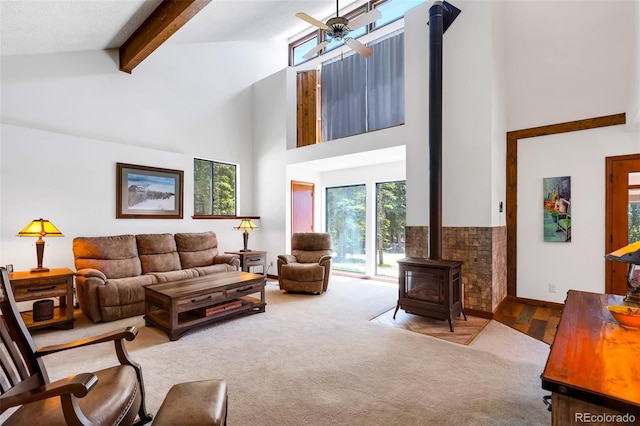 60 Jackson, Alma, CO 80420 - living room with a wood stove, high vaulted ceiling, beam ceiling, a ceiling fan, and carpet flooring