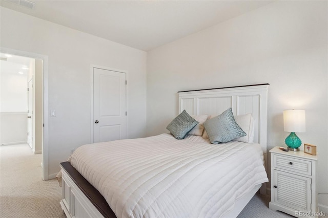 bedroom with baseboards, visible vents, and light carpet