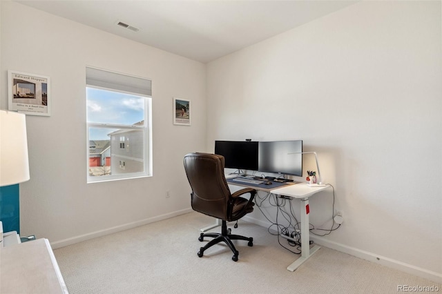 office featuring visible vents, baseboards, and carpet