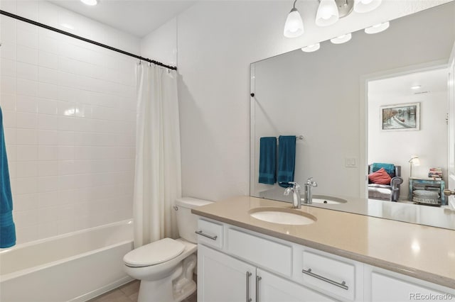 full bathroom featuring toilet, shower / bath combo, vanity, and tile patterned flooring