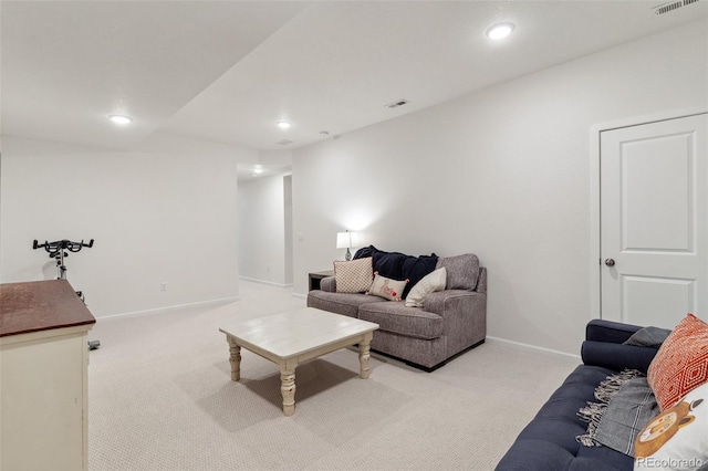 living area with visible vents, light colored carpet, and baseboards