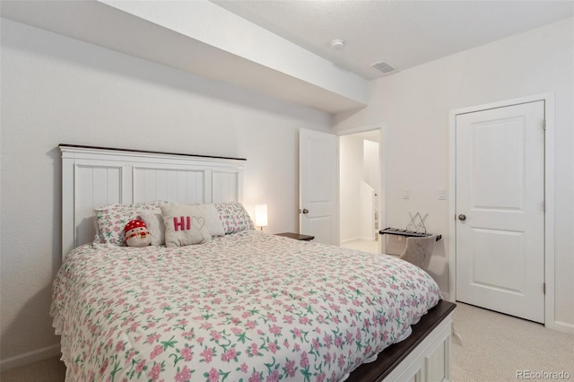 bedroom with light carpet, visible vents, and baseboards