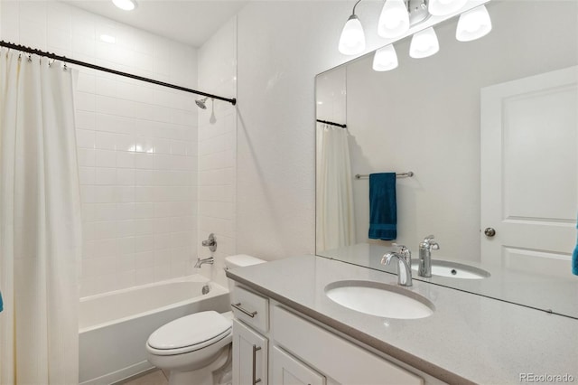 bathroom featuring toilet, vanity, and shower / tub combo