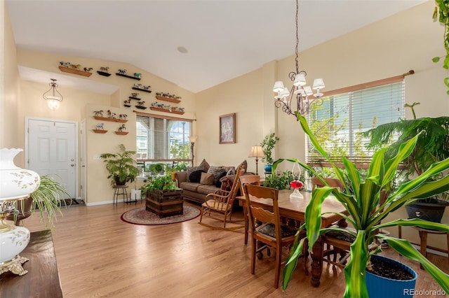 10554 Atwood Cir, Littleton, CO 80130 - interior space featuring a chandelier, baseboards, high vaulted ceiling, and wood finished floors