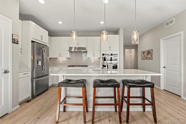 21426 E Stanford Ave, Aurora, CO 80015 - kitchen with appliances with stainless steel finishes, light countertops, light wood-type flooring, and recessed lighting