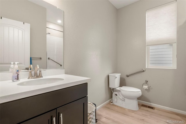 21426 E Stanford Ave, Aurora, CO 80015 - full bathroom featuring vanity, wood finished floors, and a shower