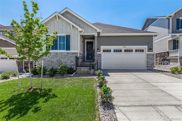 craftsman-style house featuring a front lawn and a garage