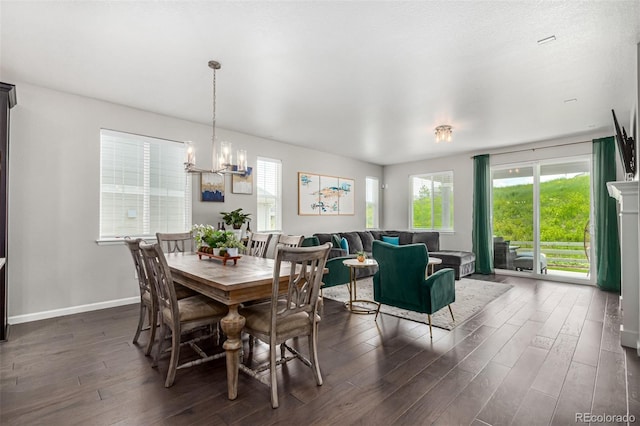 dining room featuring a chandelier and dark wood-type flooring