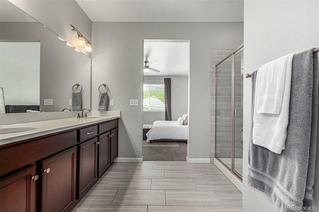 bathroom with ceiling fan, vanity, and a shower with shower door