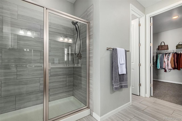 bathroom featuring a shower with door