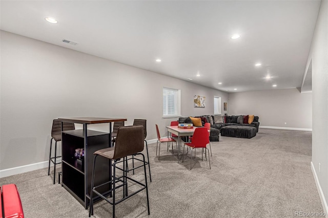 dining area featuring light carpet