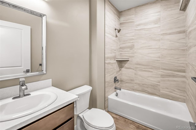 full bathroom featuring tiled shower / bath, vanity, toilet, and wood-type flooring