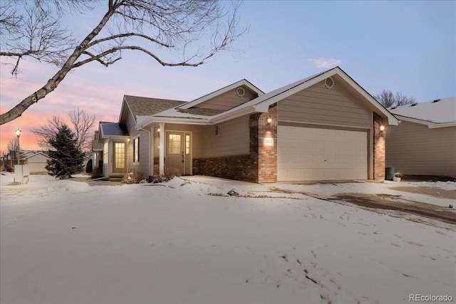 view of front of home with a garage and brick siding