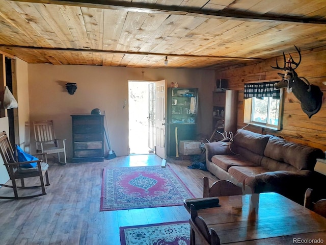 living room featuring hardwood / wood-style flooring, wood walls, and wooden ceiling