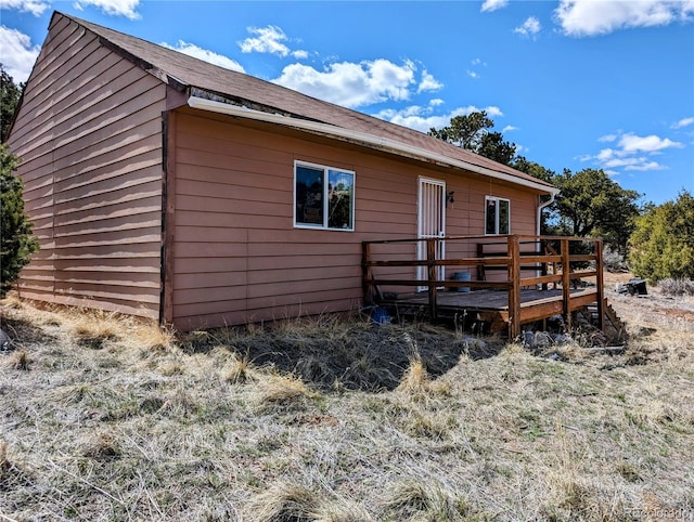 back of house featuring a wooden deck