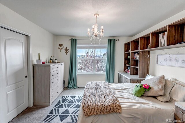 bedroom with an inviting chandelier and light colored carpet