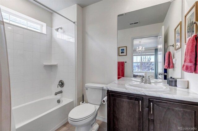 bathroom featuring shower / bathtub combination, a wealth of natural light, toilet, and visible vents